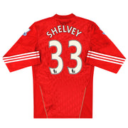 2010-12 Liverpool Techfit Camiseta de jugador local Shelvey #33 *Impecable* Manga Larga L
